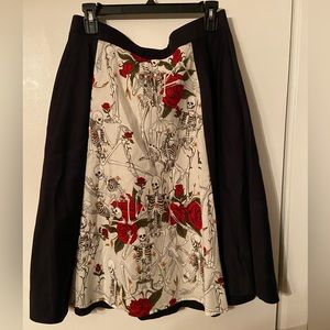 Black and white skirt that has red roses and skeletons